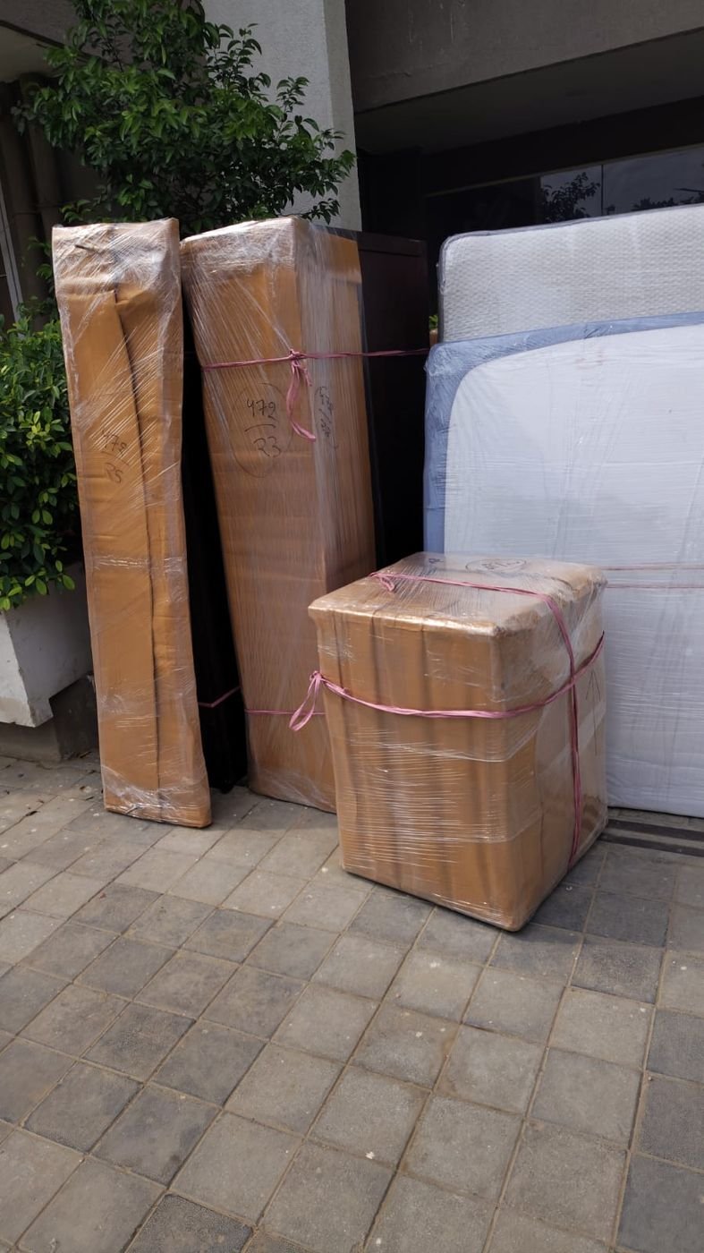 Mattress and cartons staged at the doorstep before loading