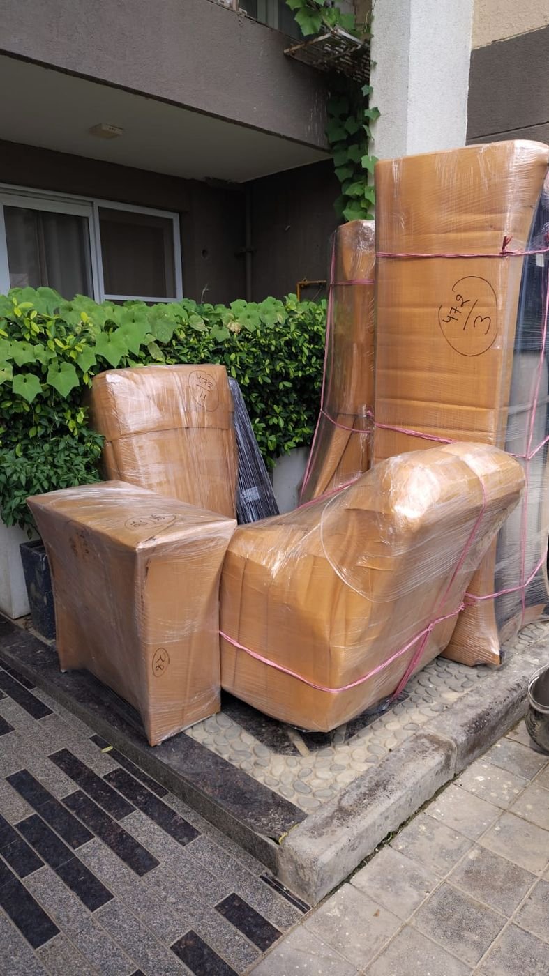 Packed cartons and wrapped furniture ready before the movers finish loading